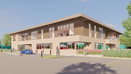 Architectural rendering of the new Roselle Public Library building to be built on Maple Avenue. View of the southest corner of the two-story building. Trees and flowering plants surrounding the beige and brown building.